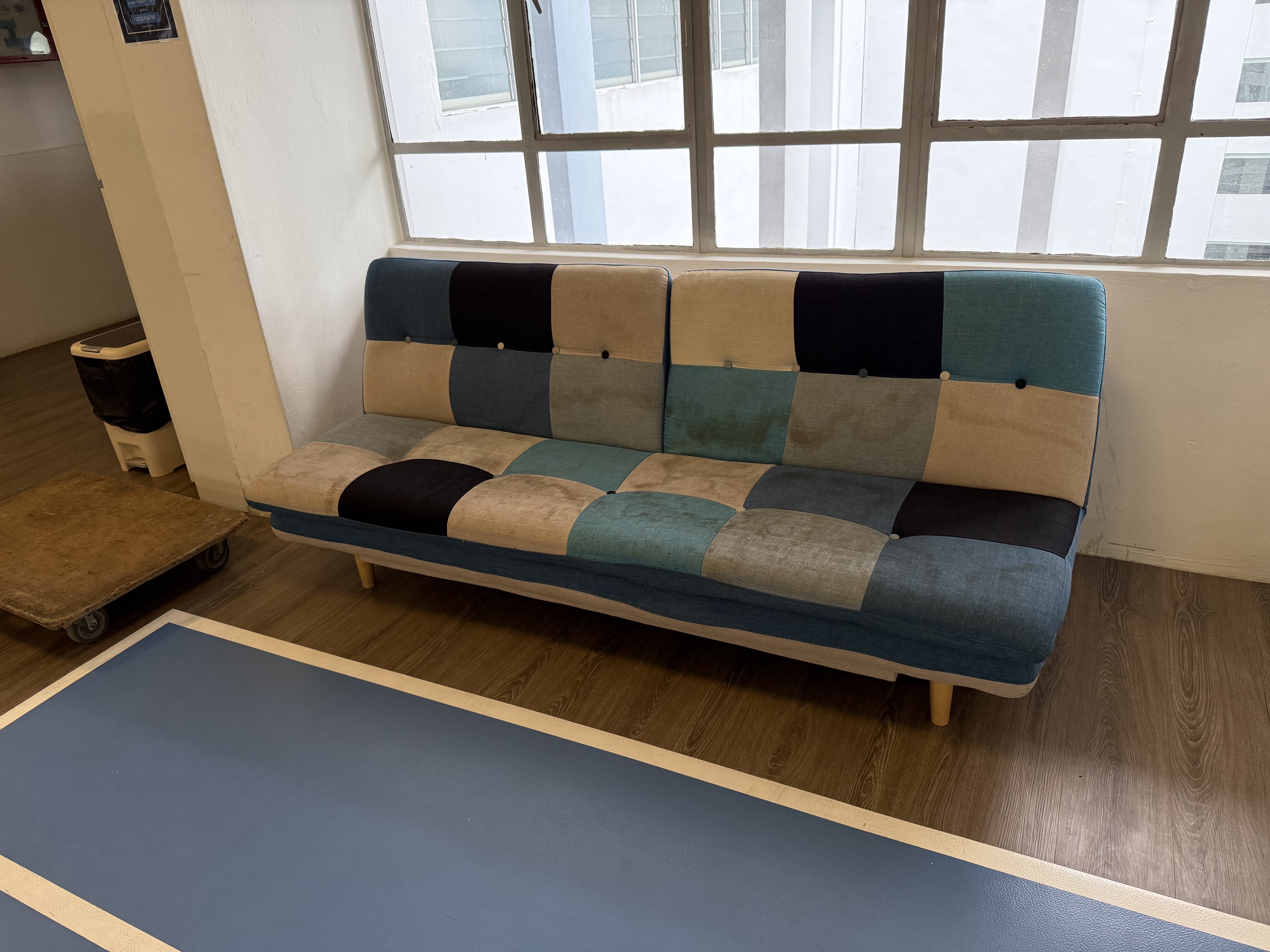 Patchwork sofa being cleared out from a residential unit in Queenstown.