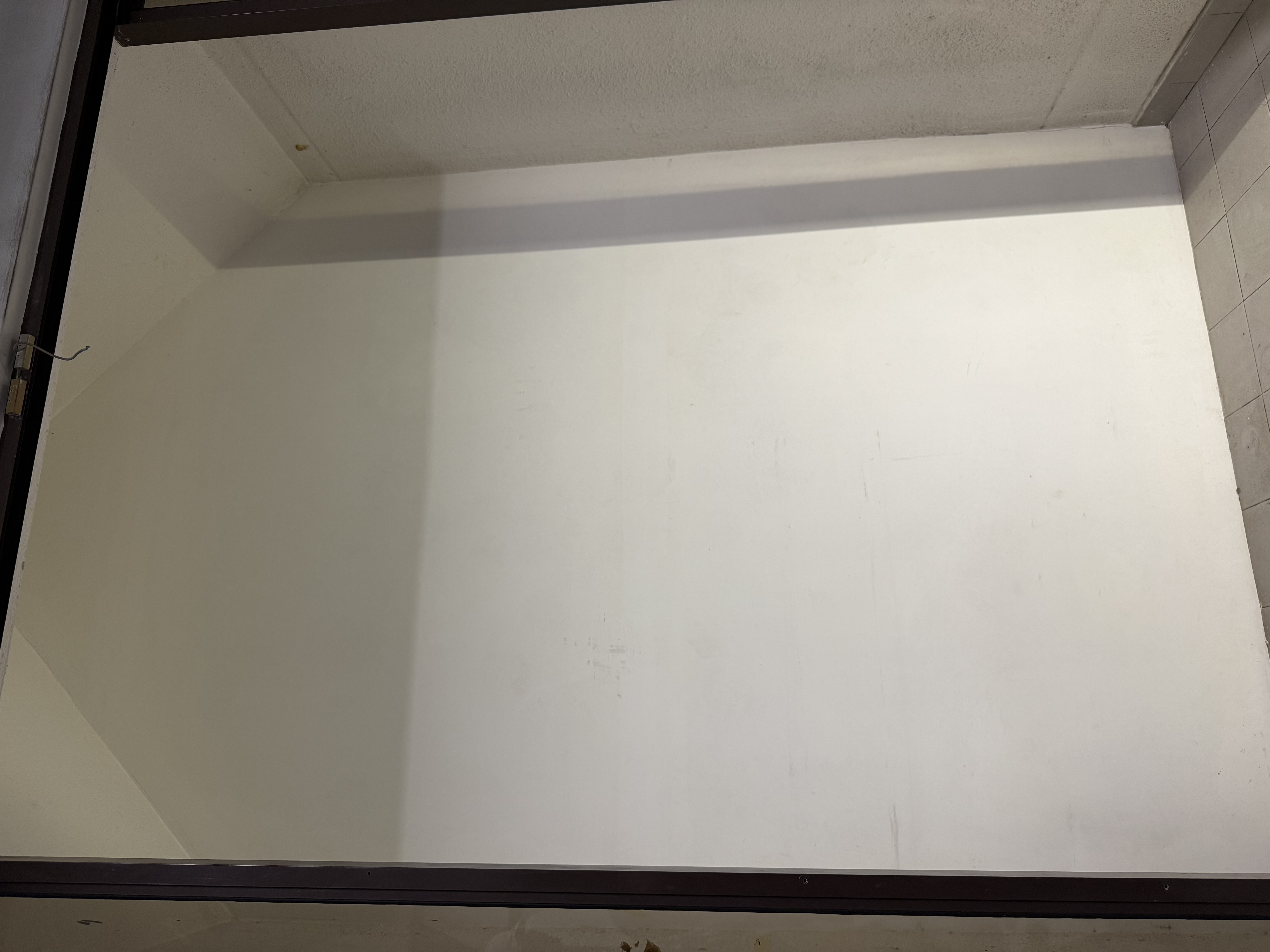 Interior partition wall in a Pasir Panjang landed-property unit, stripped back before renovation work begins.