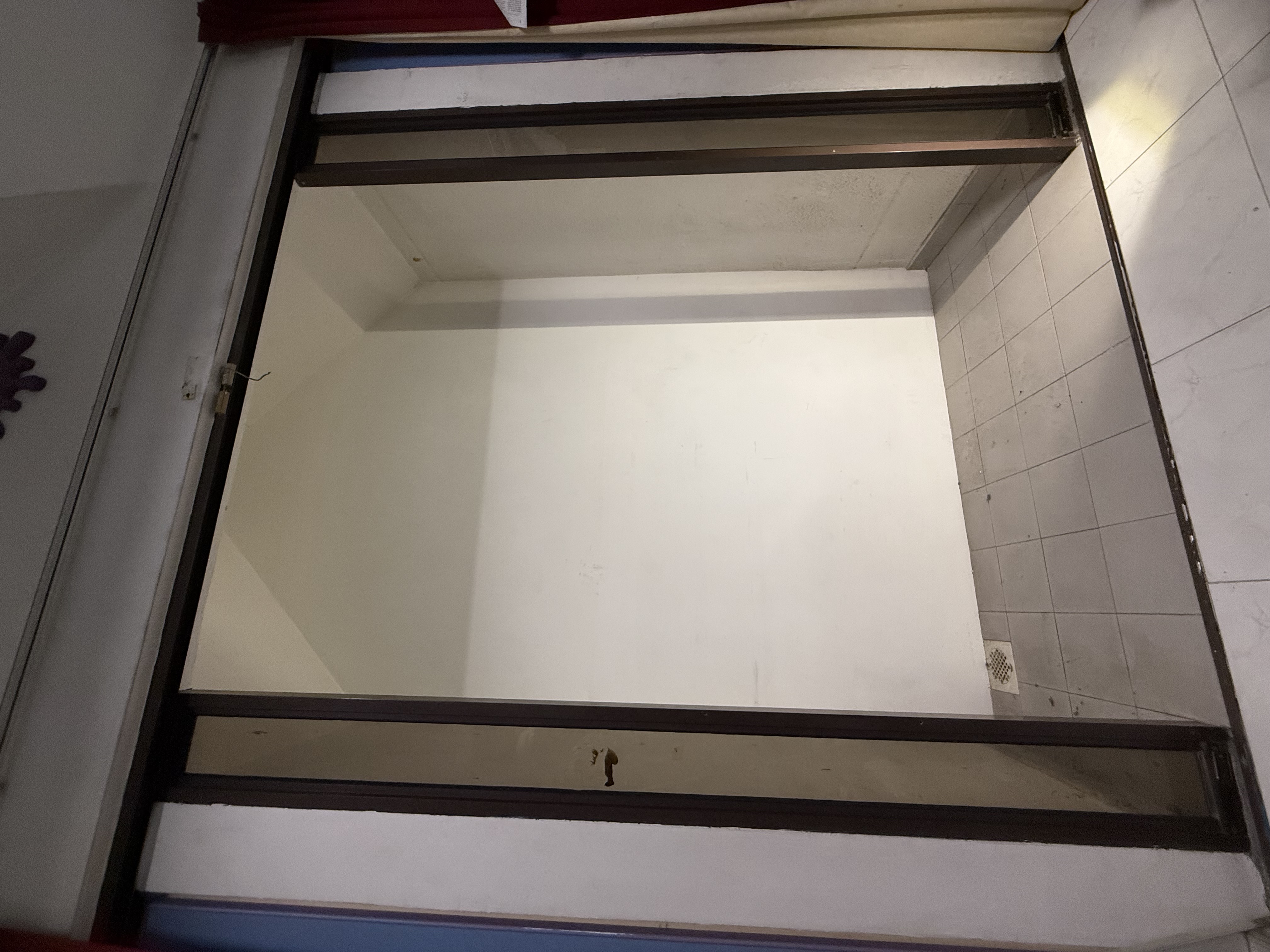 Interior partition wall in a Pasir Panjang landed-property unit, stripped back before renovation work begins.