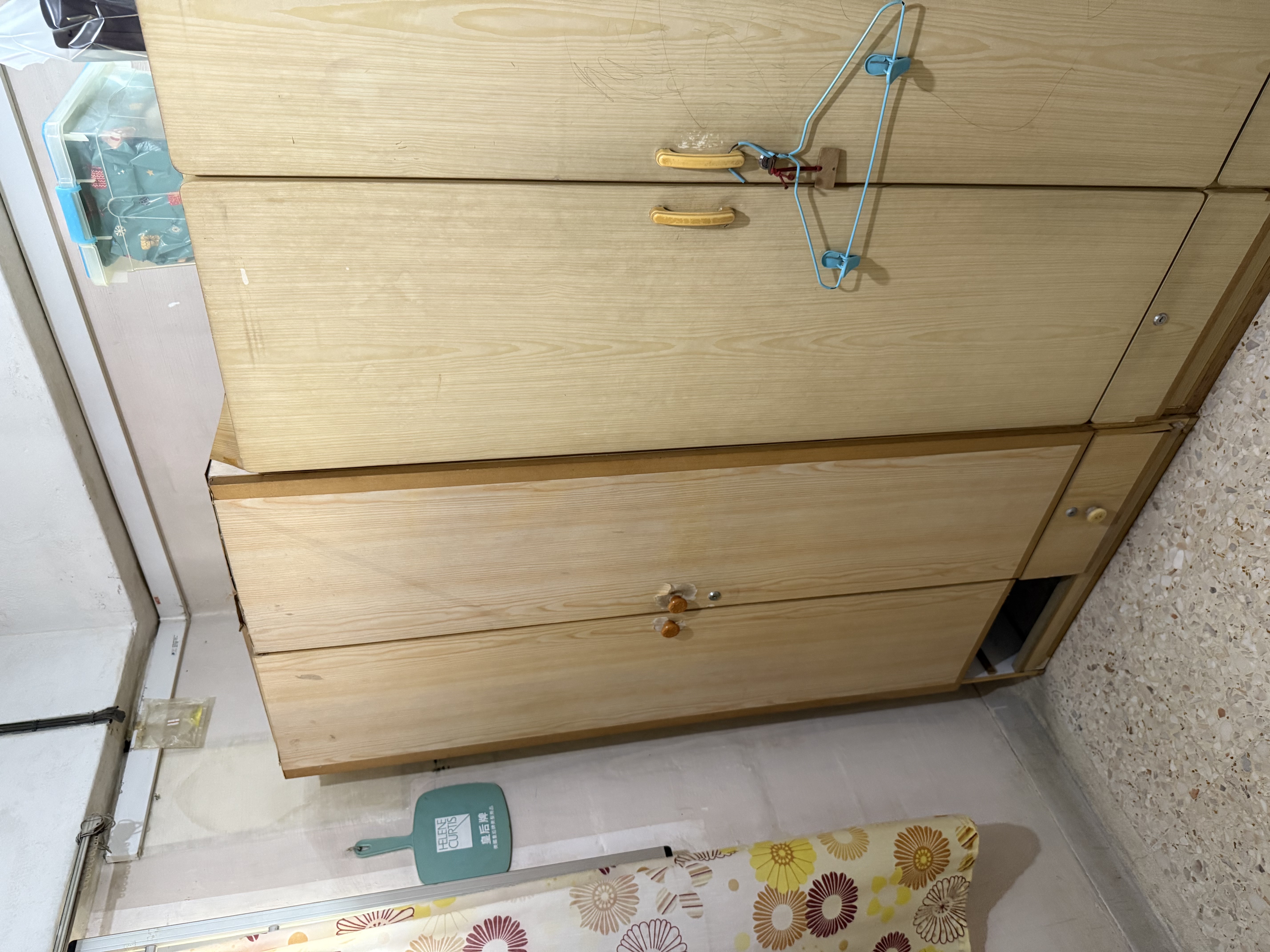 Wooden wardrobe in an HDB unit waiting for clearance — a whole intact piece like this won't be picked up by town council bulky-item collection without prior dismantling.