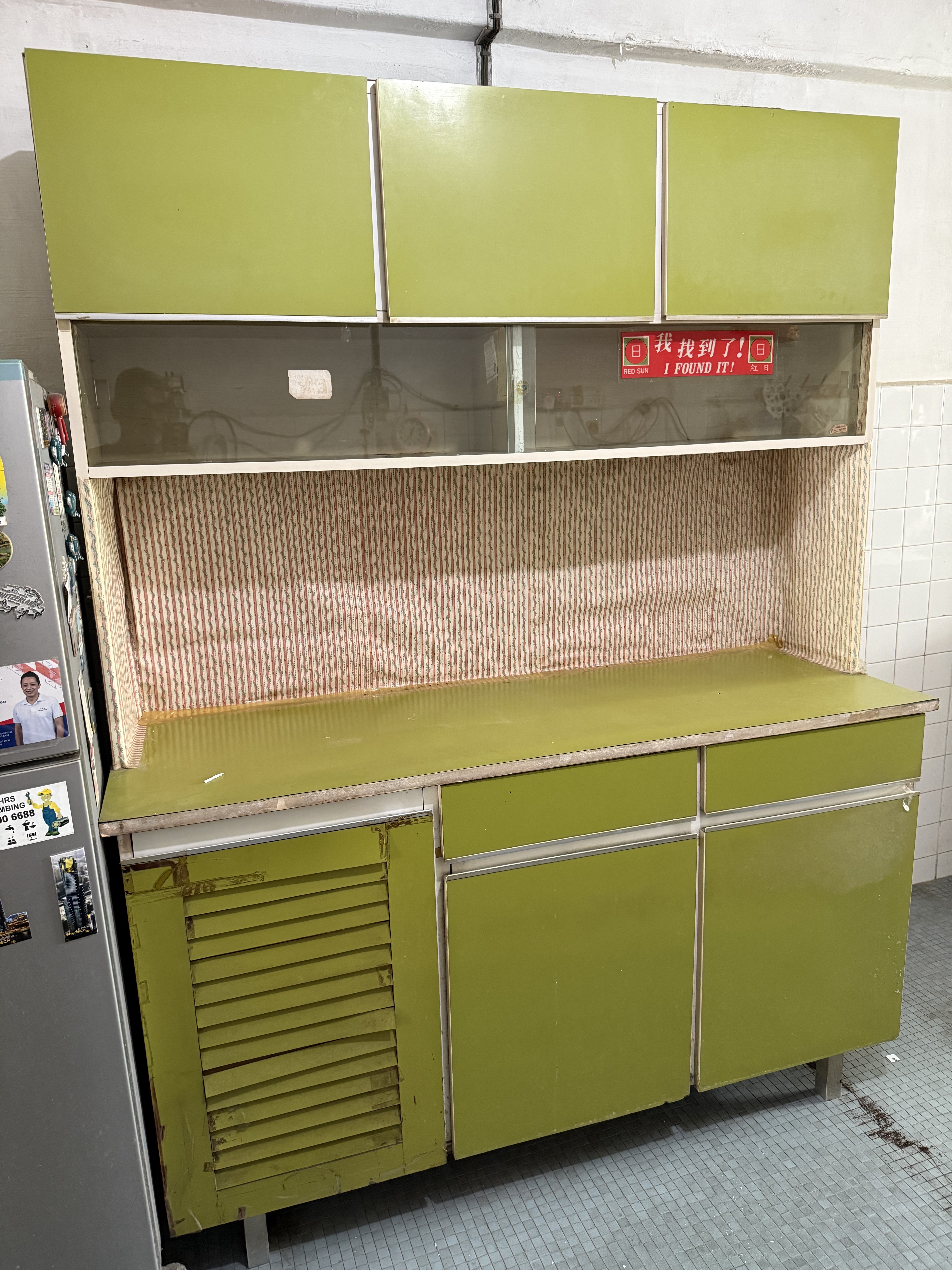 Discarded vintage green kitchen cabinet unit cleared from a Ang Mo Kio HDB flat.